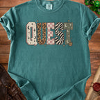 Teal Comfort Colors t-shirt with "QUEST" in varied patterns and D20 dice.