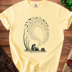 Yellow t-shirt with black graphic of a goblin pouring keys from a bag surrounded by bats and a pumpkin.