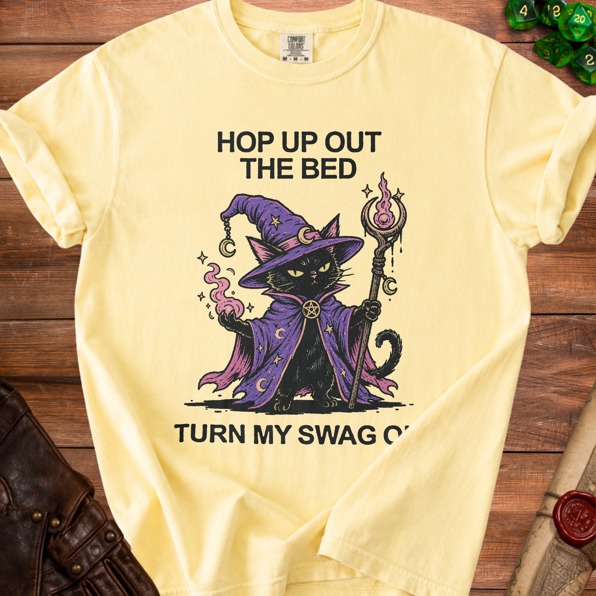 Yellow t-shirt with wizard cat graphic and text "Hop Up Out The Bed Turn My Swag O'".