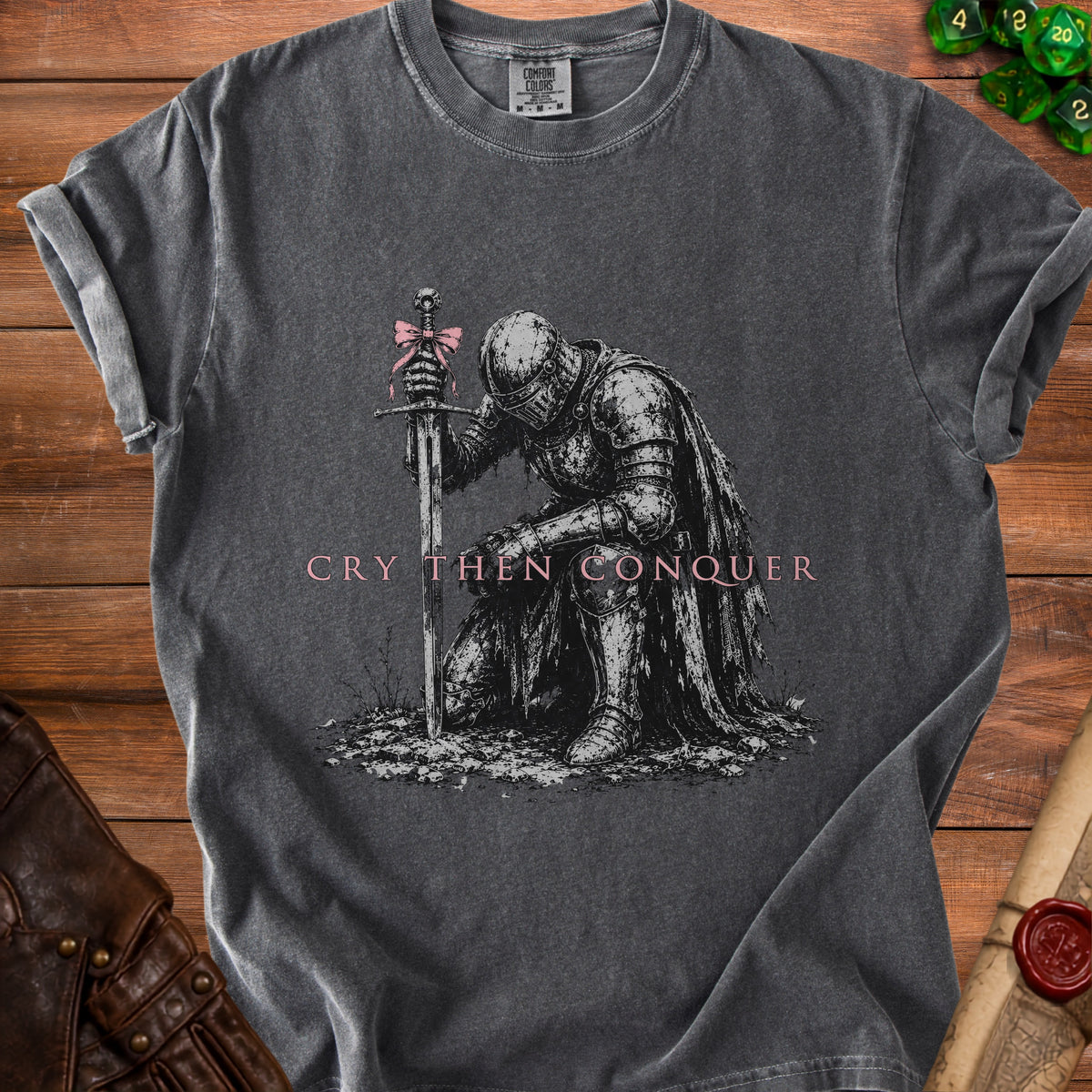 Dark grey t-shirt with knight kneeling, sword, pink bow, and text "CRY THEN CONQUER".