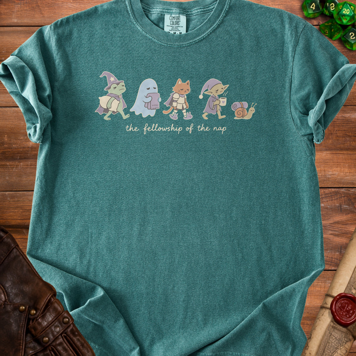 Green t-shirt with "the fellowship of the nap" text and cartoon characters.