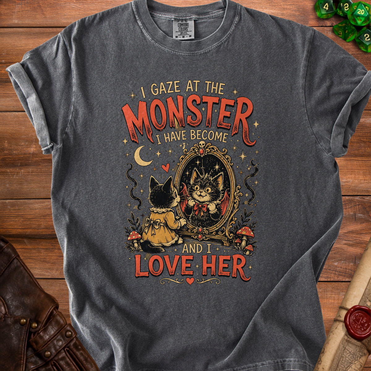 Black t-shirt with graphic of cat seeing its monster self in mirror; "I gaze at the monster I have become and I love her."