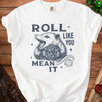 White t-shirt with a graphic of a possum holding dice and the text "ROLL LIKE YOU MEAN IT".
