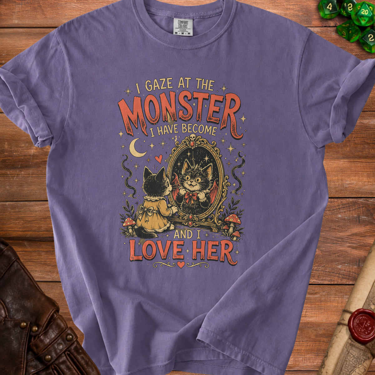 Purple t-shirt with graphic: cat gazing in mirror, text "I gaze at the monster I have become and I love her."