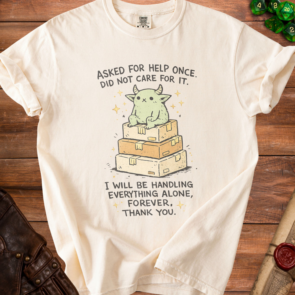 Cream t-shirt with illustration of a creature on boxes and text "Asked for help once. Did not care for it. I will be handling everything alone, forever, thank you."