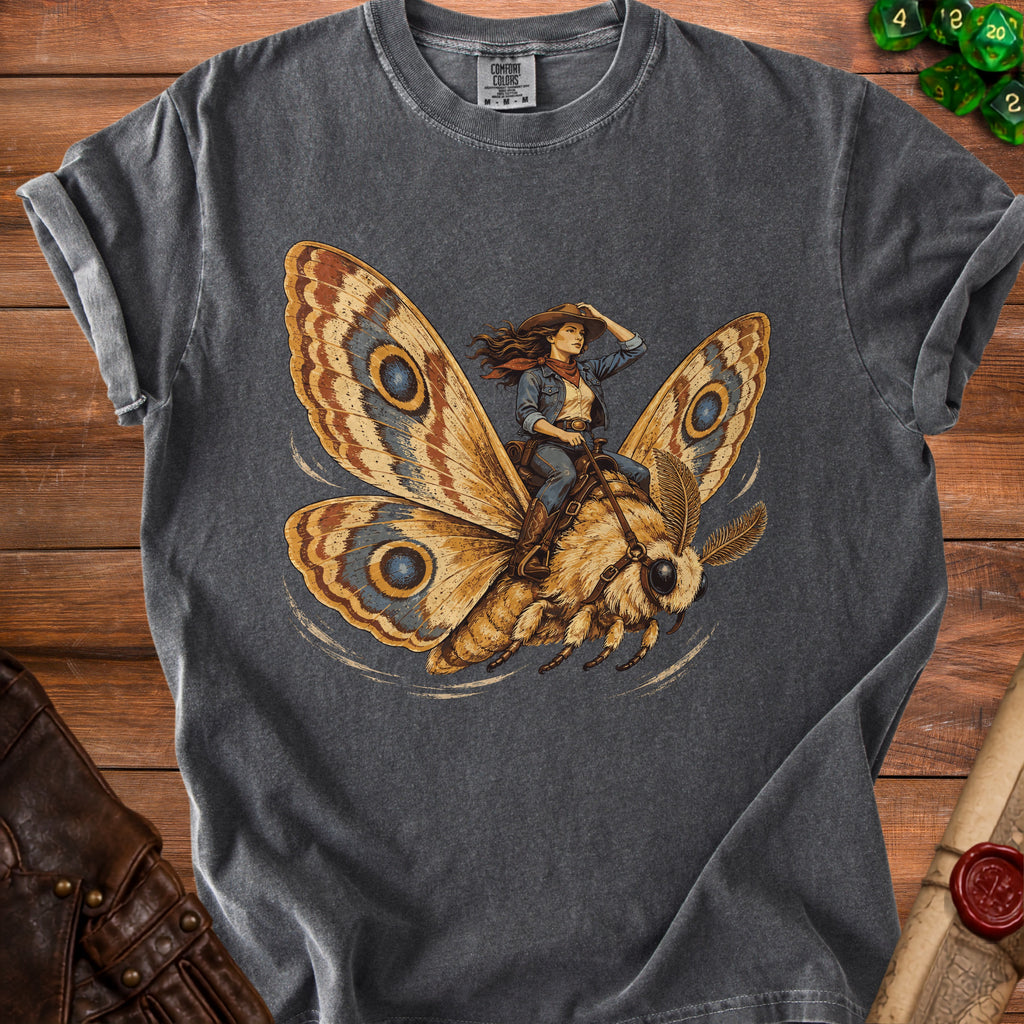 Graphic tee featuring a woman in cowboy attire riding a moth.
