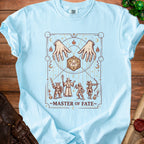 Light blue t-shirt with "Master of Fate" design featuring hands, dice, and fantasy characters.