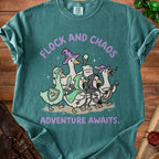 Teal t-shirt with cartoon geese dressed as fantasy adventurers. Text reads "Flock and Chaos" and "Adventure Awaits."