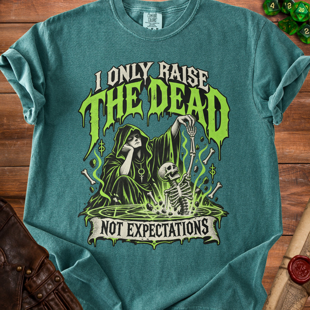 Teal shirt with graphic: Grim Reaper and skeleton, "I Only Raise The Dead Not Expectations".