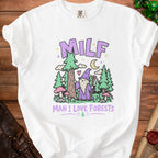 White t-shirt with cartoon wizard, trees, mushrooms, and text "MILF MAN I LOVE FORESTS".