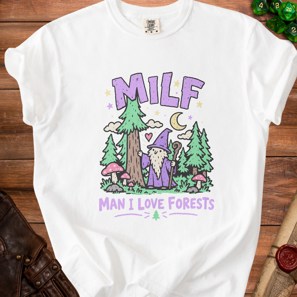 White t-shirt with cartoon wizard, trees, mushrooms, and text "MILF MAN I LOVE FORESTS".