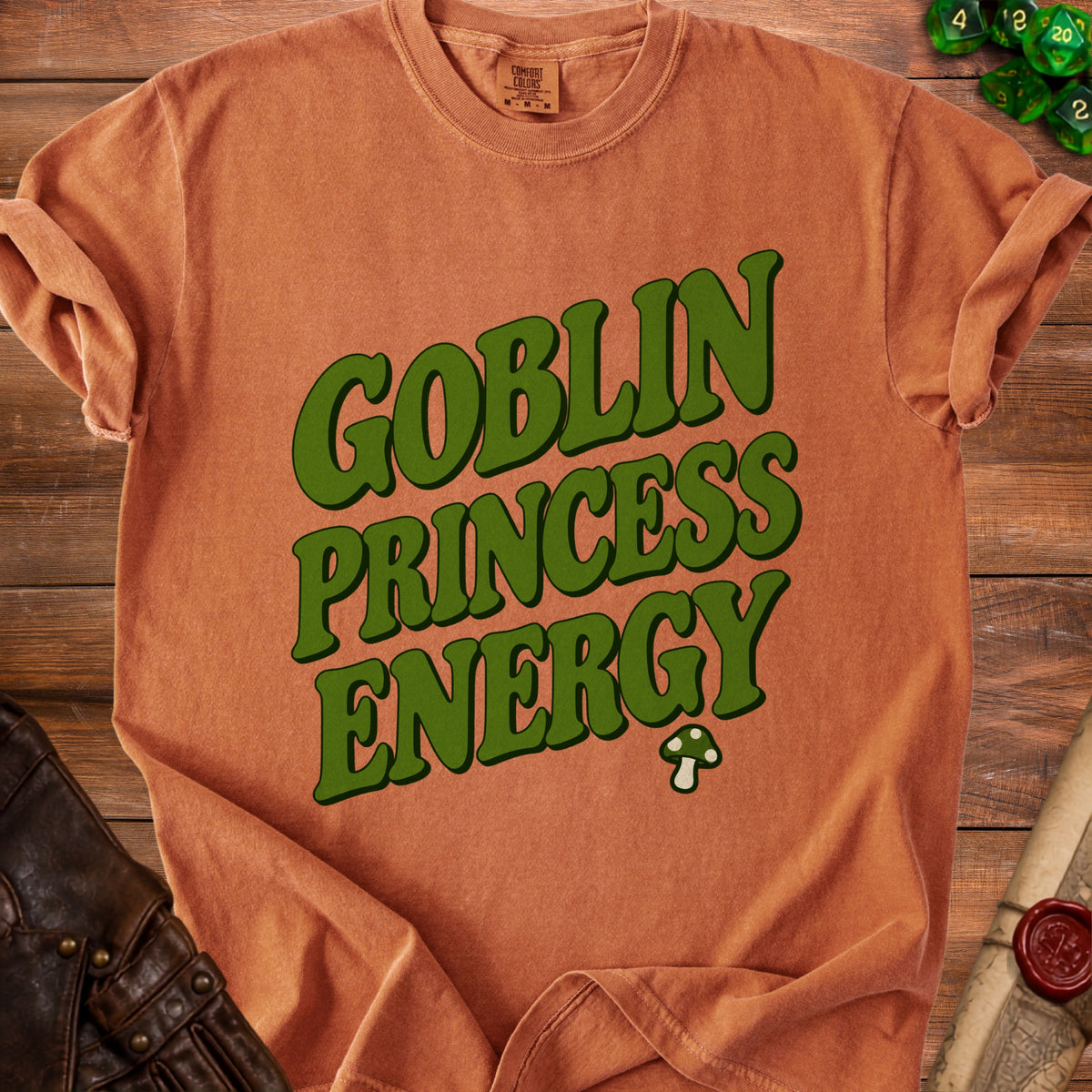 Orange t-shirt with "Goblin Princess Energy" text and a mushroom graphic.
