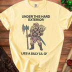 Yellow t-shirt with "UNDER THIS HARD EXTERIOR LIES A SILLY LIL GI" text and barbarian illustration.