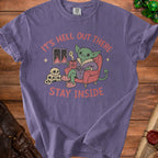 Purple t-shirt with goblin reading "It's Hell Out There Stay Inside".