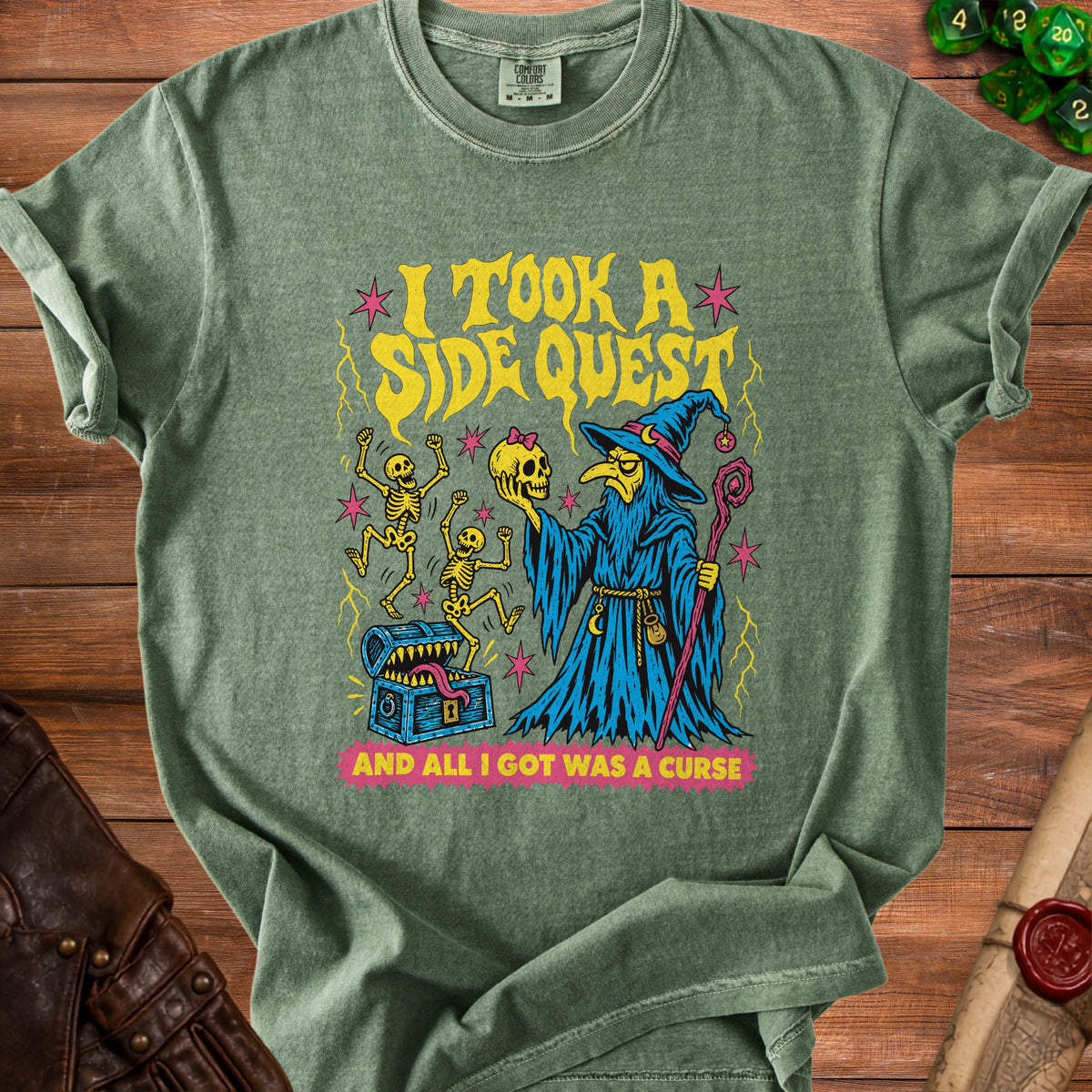Green t-shirt with wizard, skeletons, treasure chest, and text: "I TOOK A SIDE QUEST AND ALL I GOT WAS A CURSE."