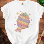 White t-shirt with graphic of a sleeping dragon wrapped in a striped scarf and stars.