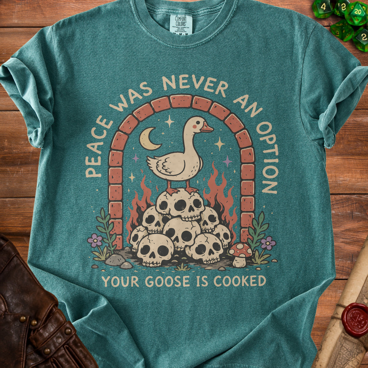 Green t-shirt with "Peace Was Never an Option" and a goose on skulls graphic.