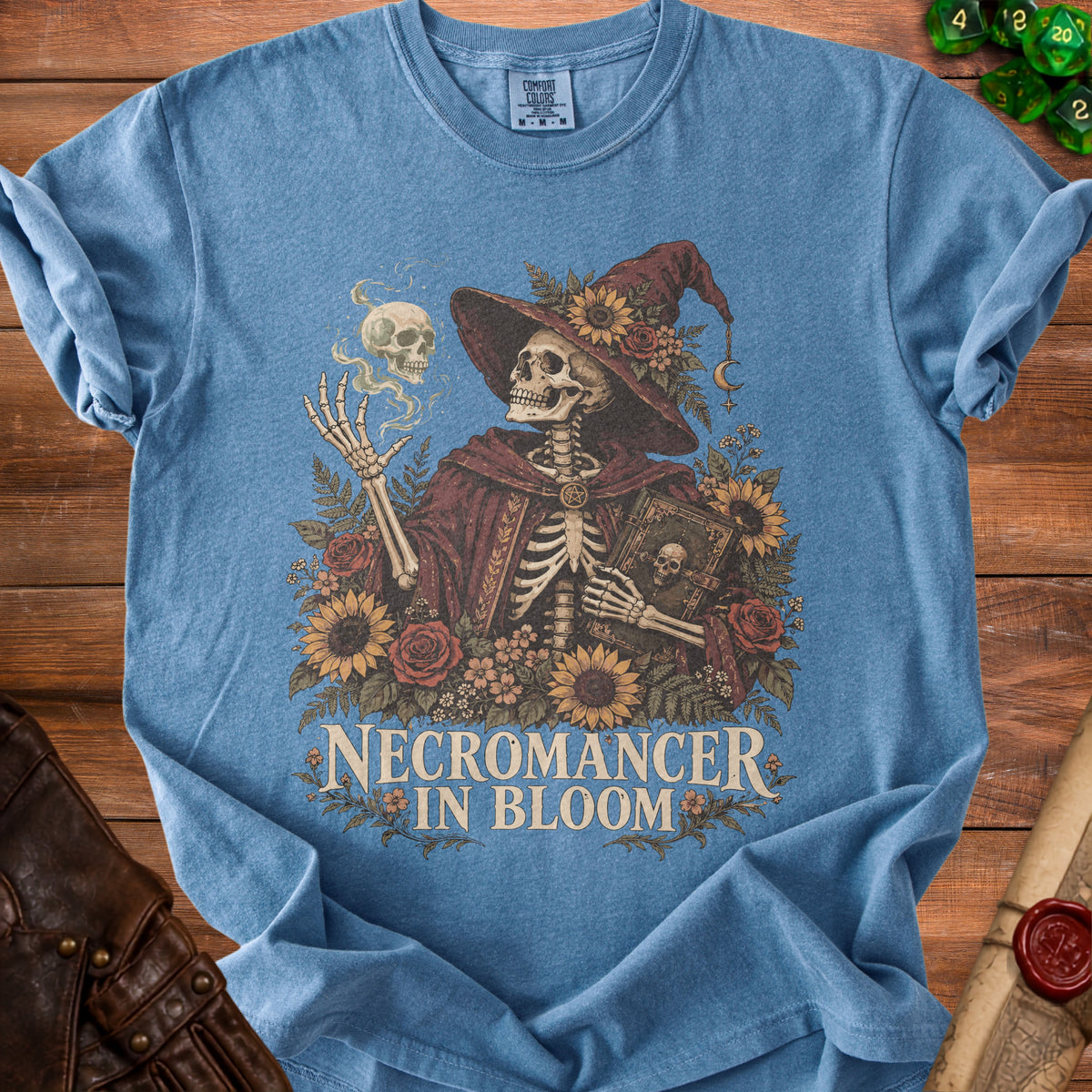Skeleton necromancer in witch hat with flowers and book, text "NECROMANCER IN BLOOM".