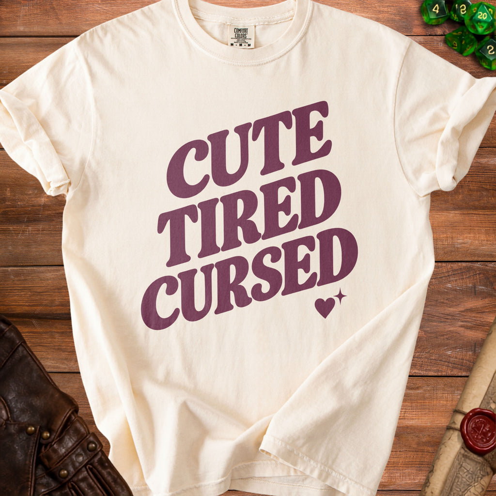 Cream Comfort Colors t-shirt with "CUTE TIRED CURSED" text and heart graphic.
