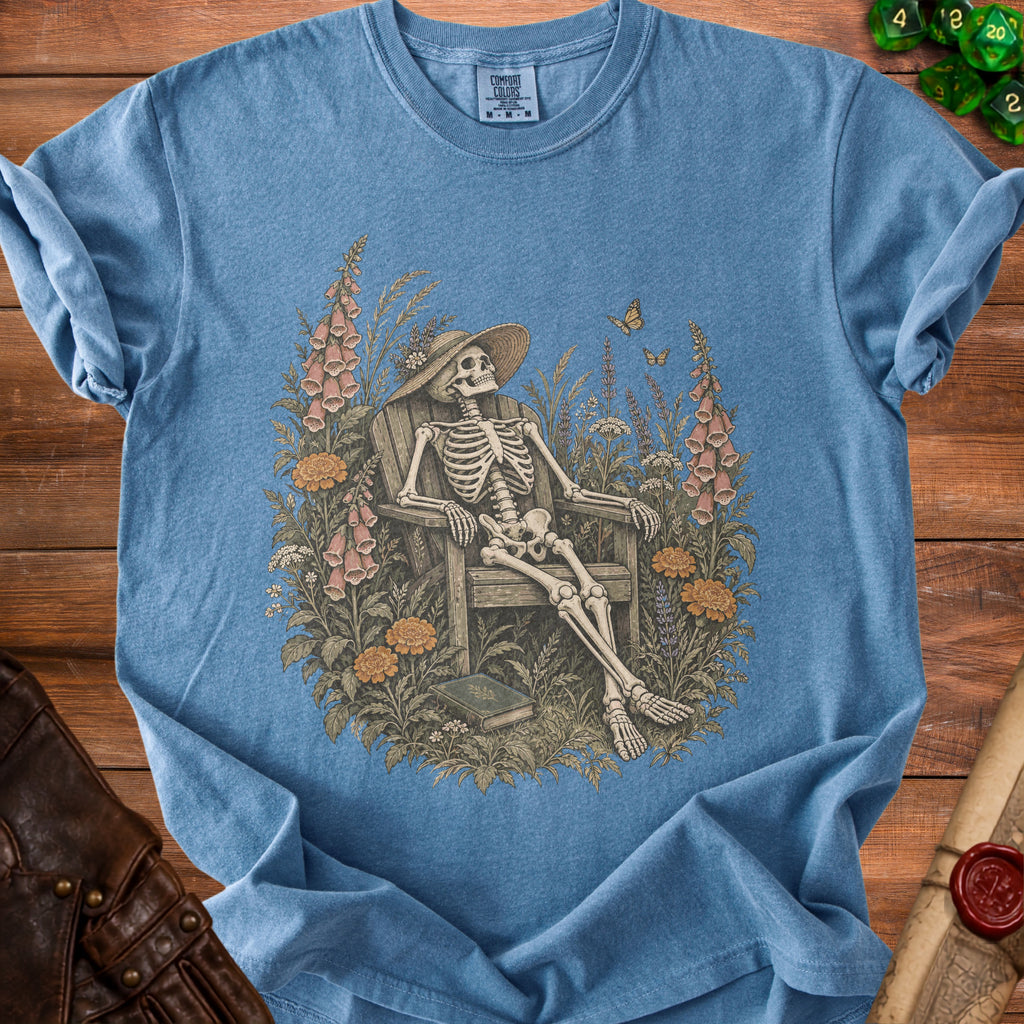 Skeleton wearing a hat sits in a chair surrounded by flowers and butterflies.