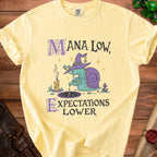 Yellow t-shirt with a wizard snail pouring potion and text "Mana Low, Expectations Lower".
