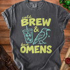Dark t-shirt with "Cold Brew & Bad Omens" text, a coffee cup, and a raven.