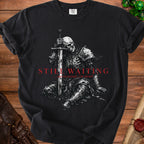 Black t-shirt with a skeleton knight graphic and text "STILL WAITING ...nevermind, I'm dead".