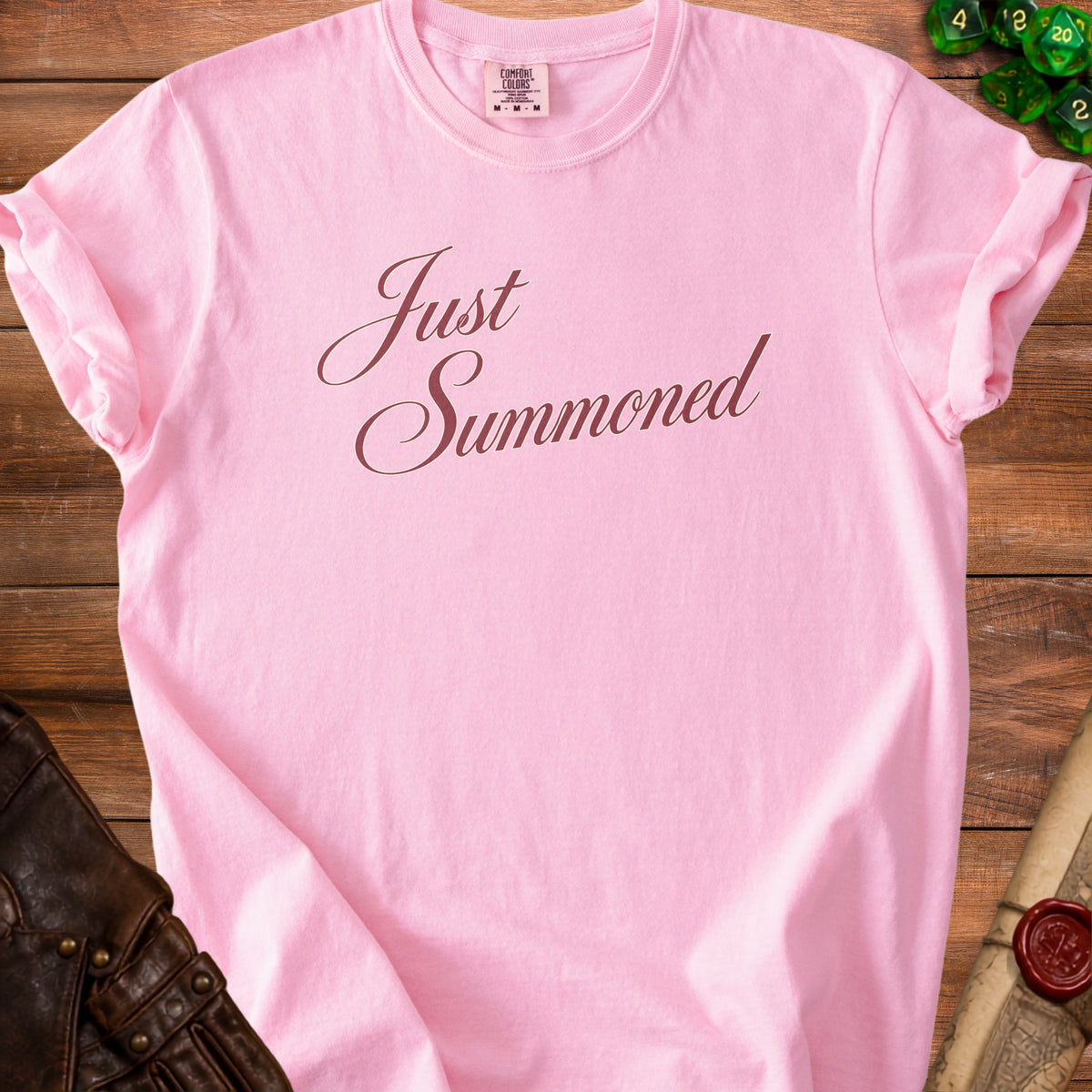 Pink t-shirt with "Just Summoned" text in brown cursive font.