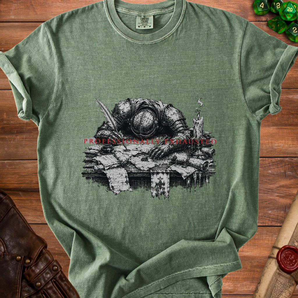 T-shirt with a knight writing, surrounded by scrolls, a candle, and text "PROFESSIONALLY EXHAUSTED".