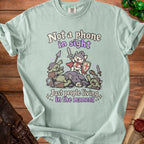 Light blue t-shirt with knights and goblins graphic and text "Not a phone in sight, Just people living in the moment".