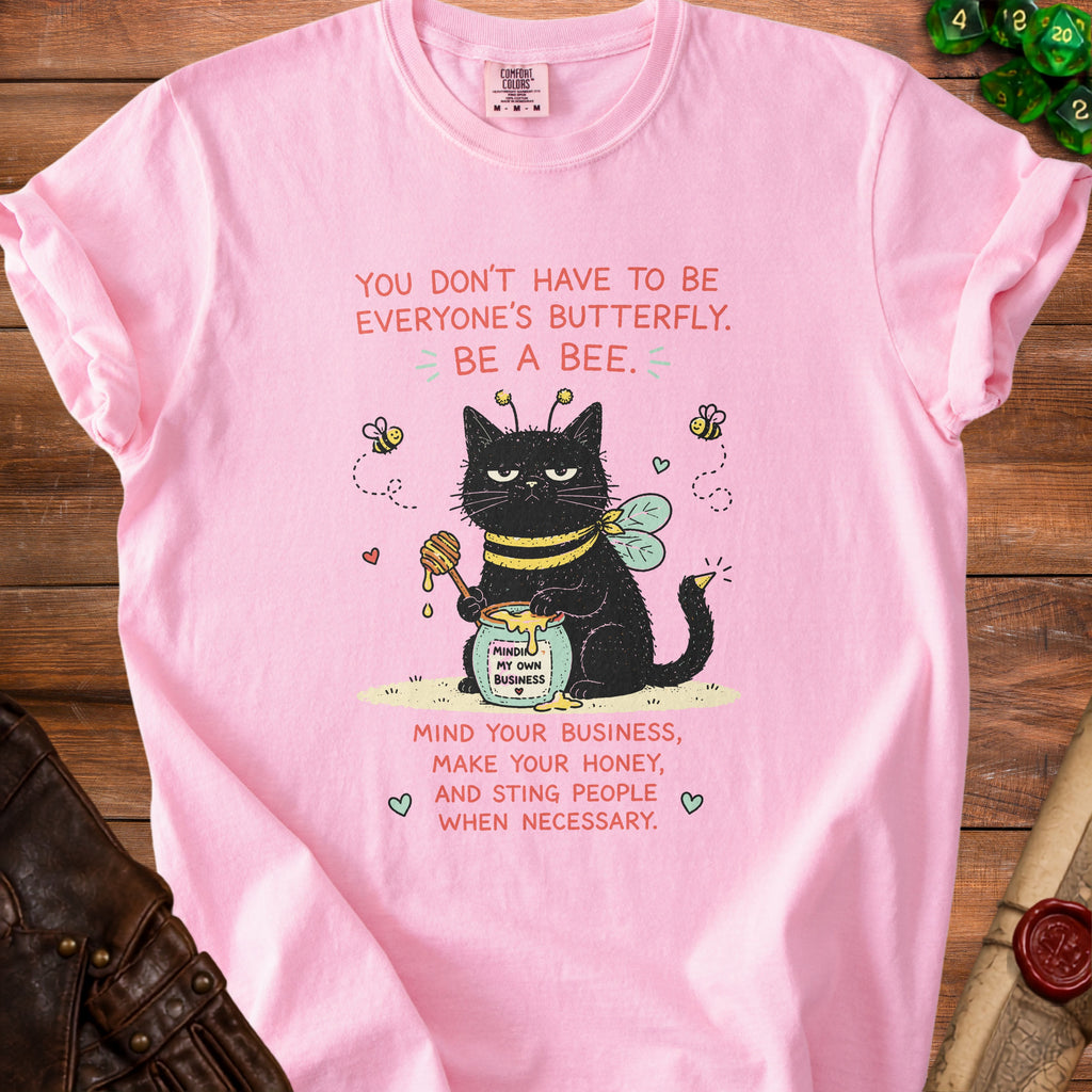 Pink t-shirt with black cat dressed as a bee and text "Be a bee. Mind your business, make your honey, and sting people when necessary."