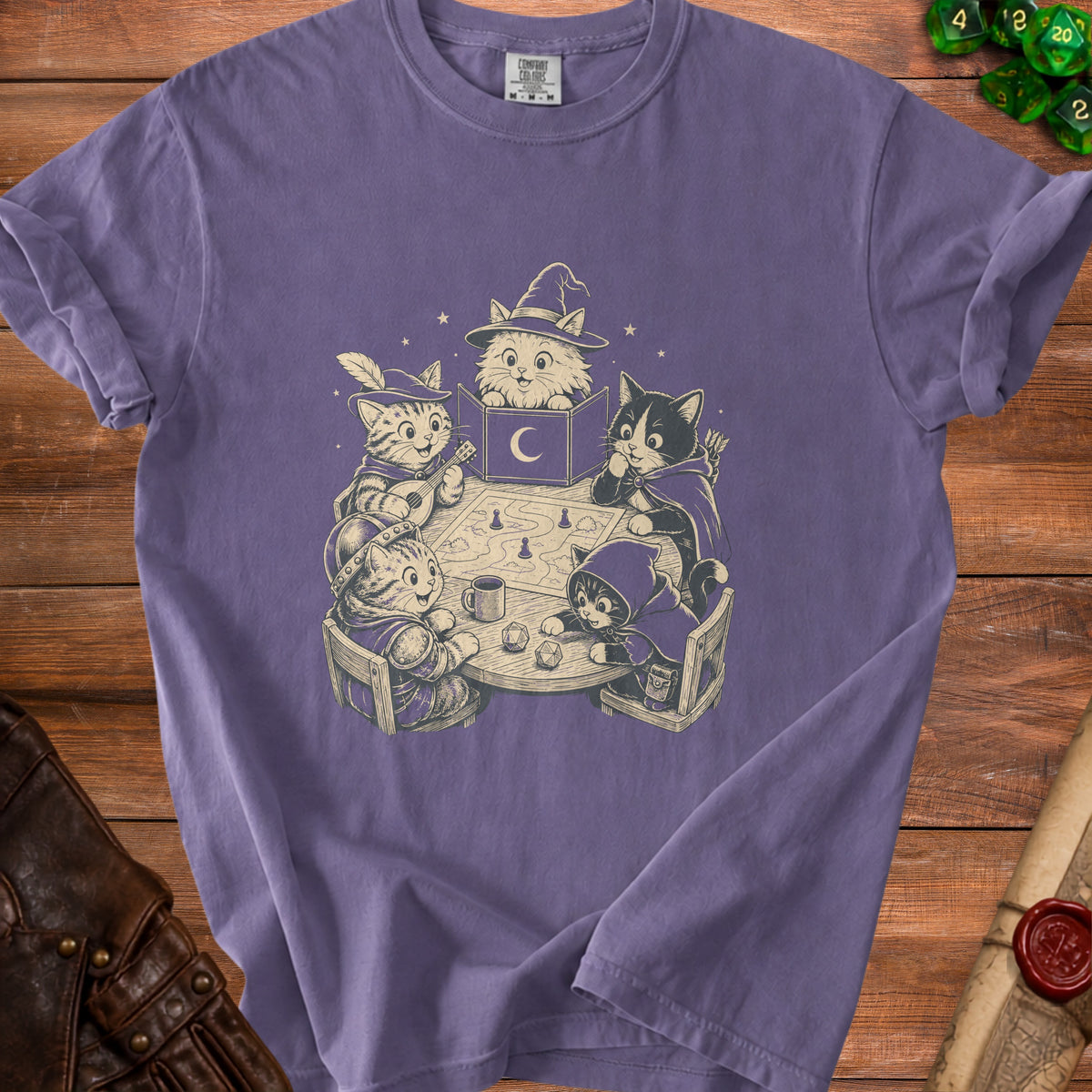 A purple t-shirt featuring a graphic print of cats playing a tabletop role-playing game.