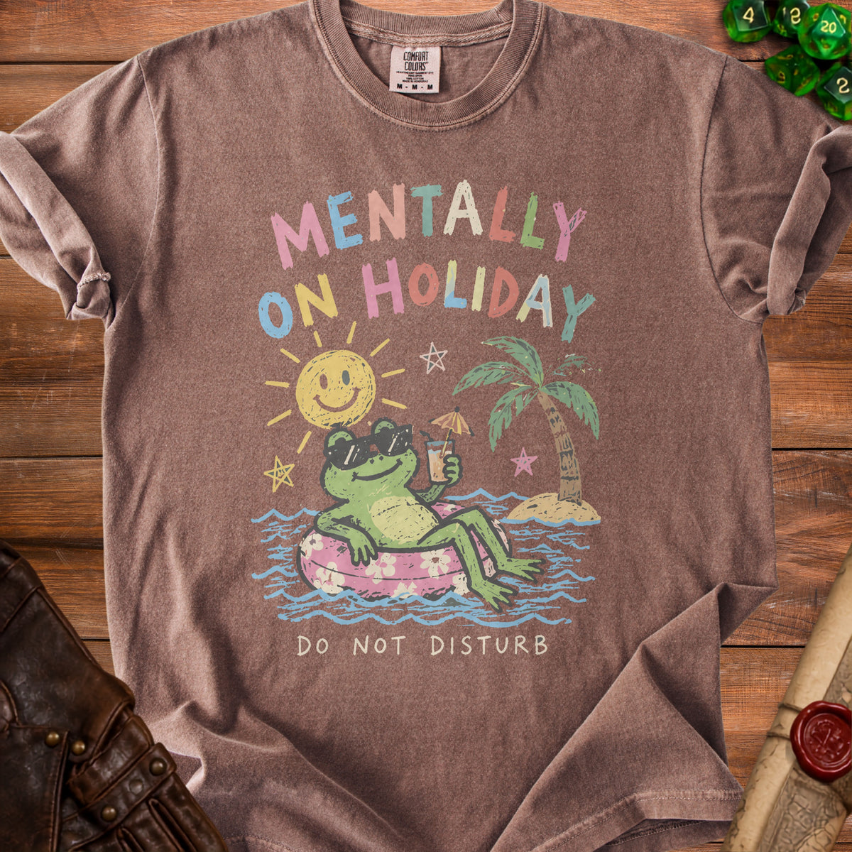 Brown t-shirt with a graphic of a frog on a float with text "Mentally on Holiday" and "Do Not Disturb".