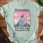 Shirt with a graphic featuring a D20 die, sword-wielding figure, and text "Remember, You only need one good roll!".