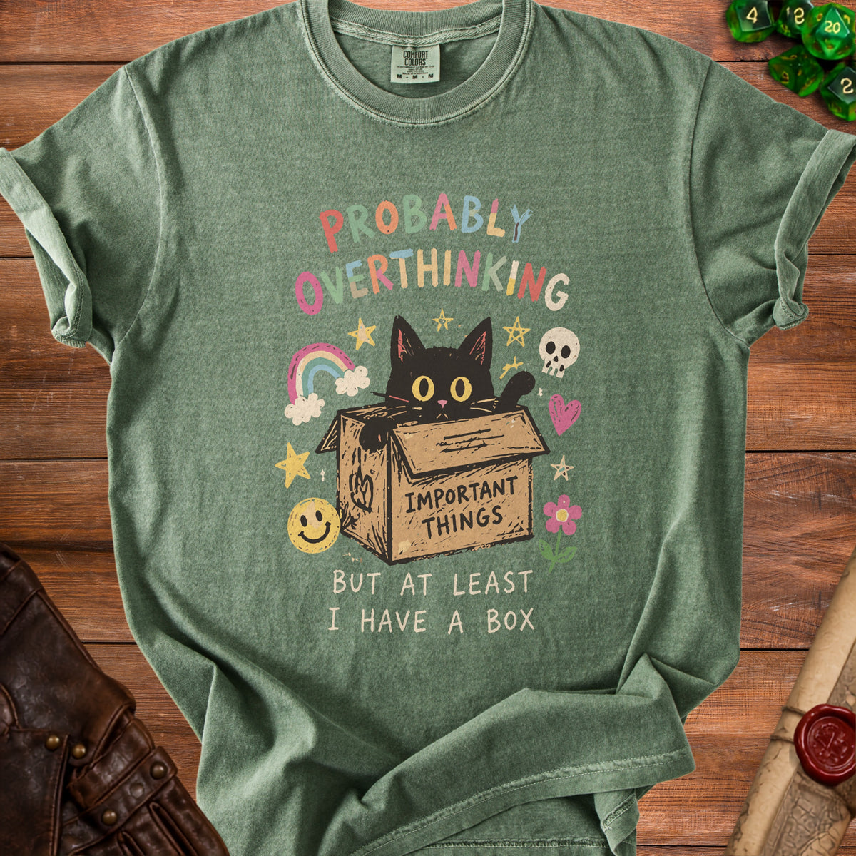 Green t-shirt with black cat in a box and "Probably Overthinking" text.