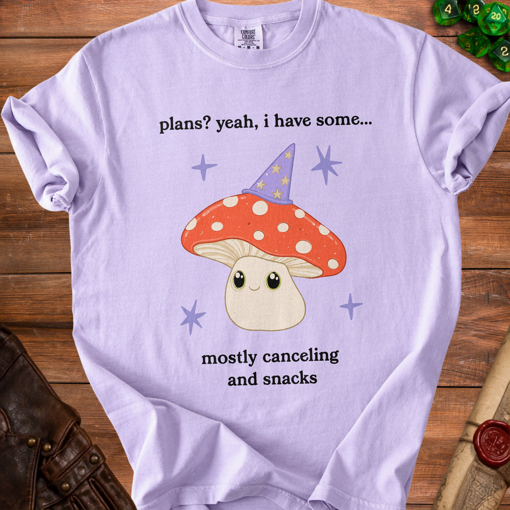 Purple t-shirt with mushroom graphic and text "plans? yeah, i have some... mostly canceling and snacks".