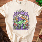 Cream t-shirt with green goblin character and "Off in Fantasy Land" text.