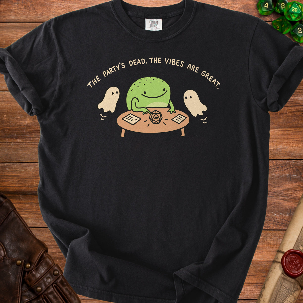 Black t-shirt with a frog, ghosts, dice, and text "The party's dead. The vibes are great."