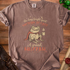 Brown t-shirt with a tired frog wearing a cape and holding a coffee cup.