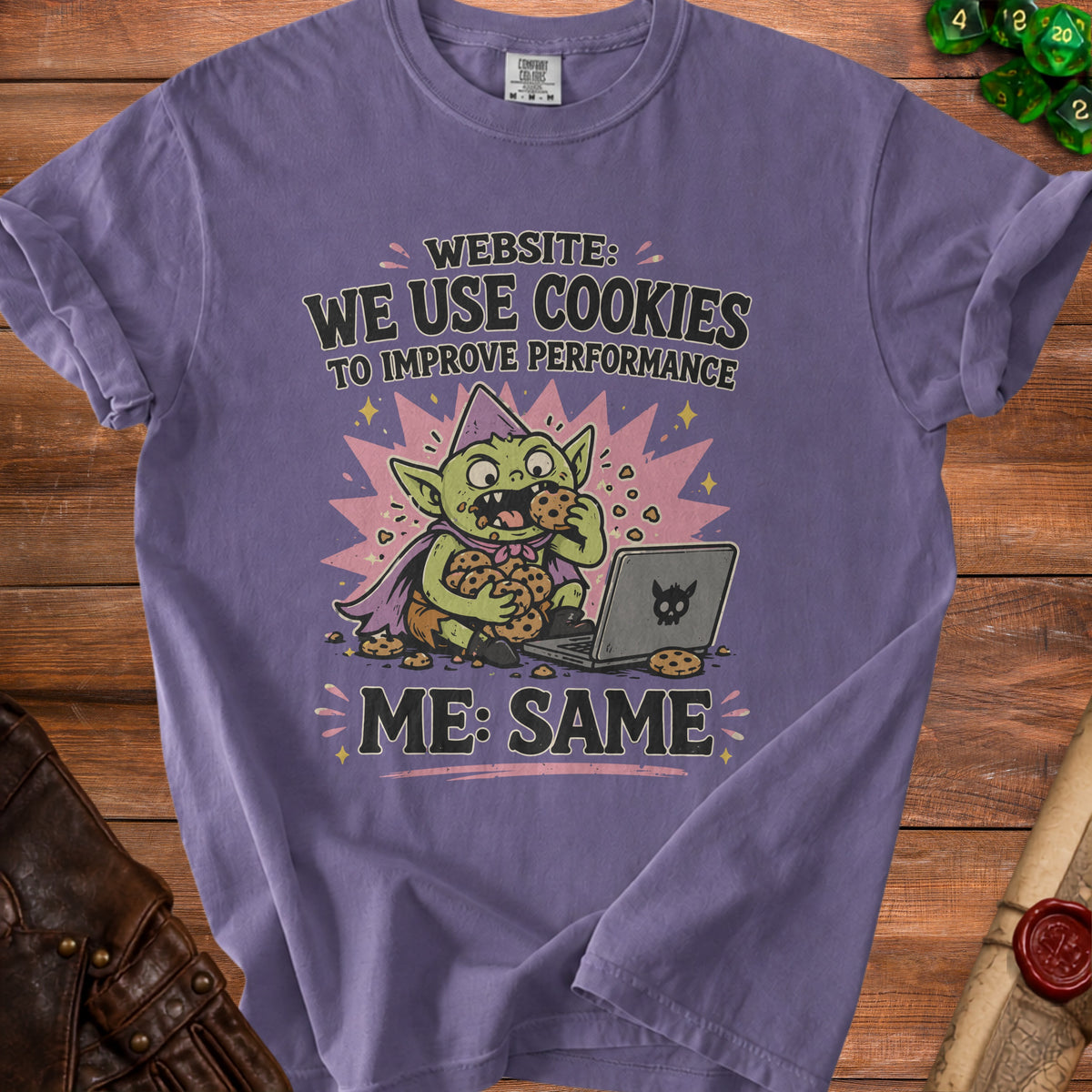 Purple t-shirt with cartoon goblin eating cookies and text "WEBSITE: WE USE COOKIES"