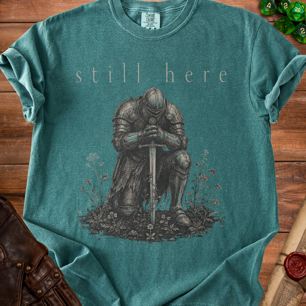 T-shirt with knight kneeling and text "still here".