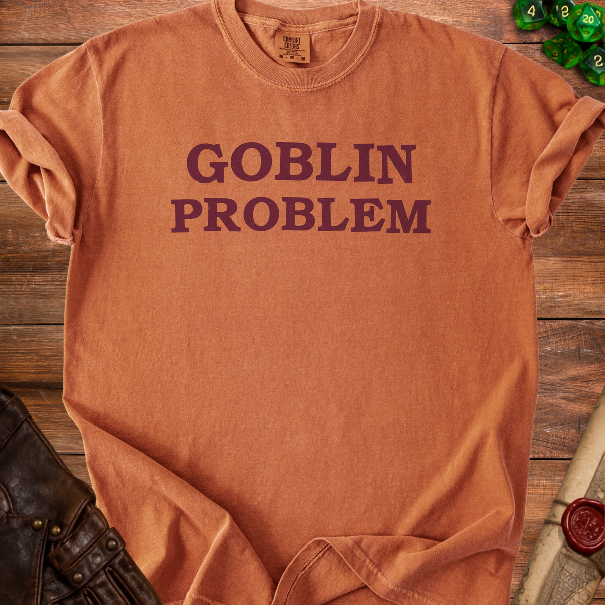 Orange t-shirt with "GOBLIN PROBLEM" text in burgundy.
