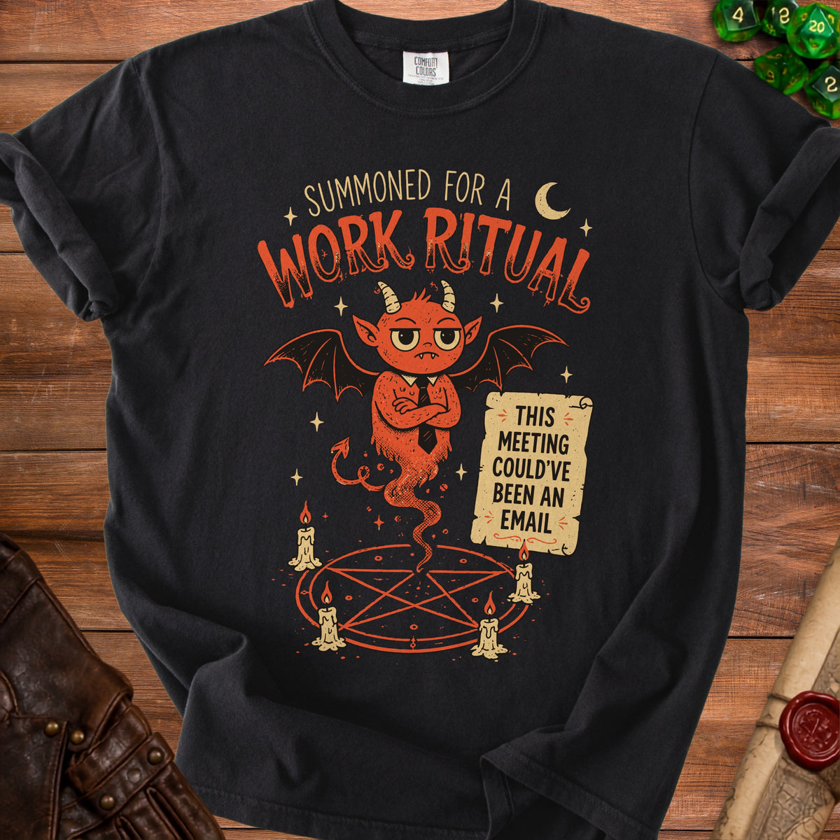 Black t-shirt graphic with devil, pentagram, candles, and text about meetings.