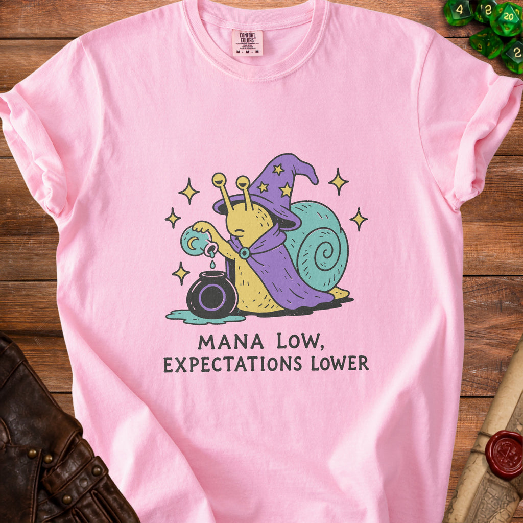 Pink t-shirt with a wizard snail graphic and "Mana Low, Expectations Lower" text.
