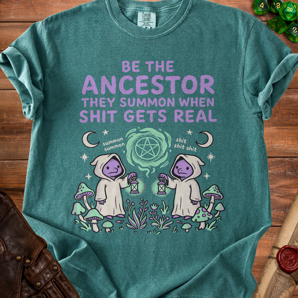 T-shirt with "Be the ancestor they summon when shit gets real" text.