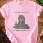 Pink t-shirt with text "Are we back in medieval times?" and cartoon wizard.
