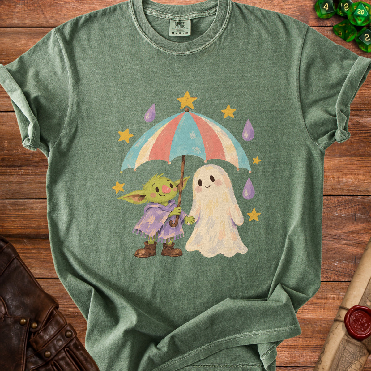 Green t-shirt featuring a green creature and ghost holding an umbrella with stars and raindrops.