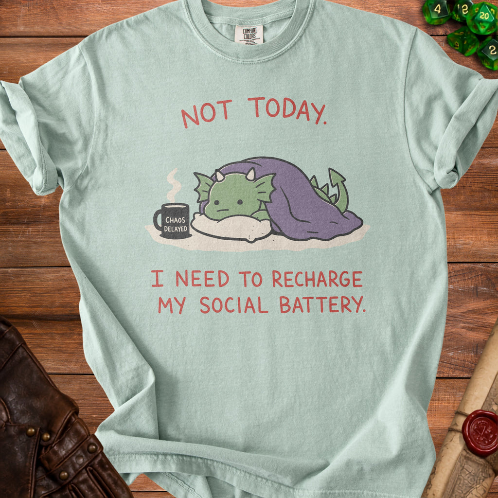 Light blue t-shirt with cartoon dragon under covers and text "Not Today. I need to recharge my social battery."