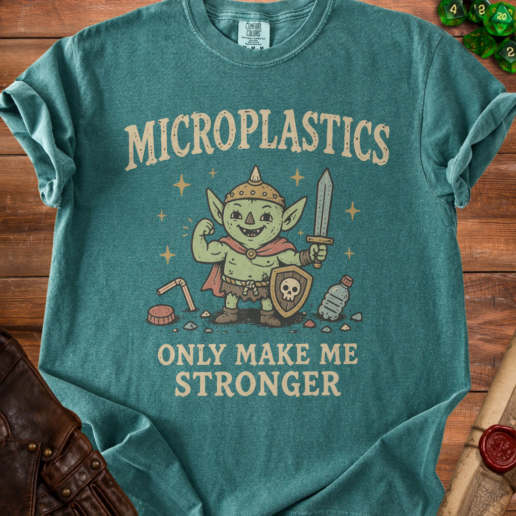 Teal t-shirt with green goblin illustration and text "MICROPLASTICS ONLY MAKE ME STRONGER".
