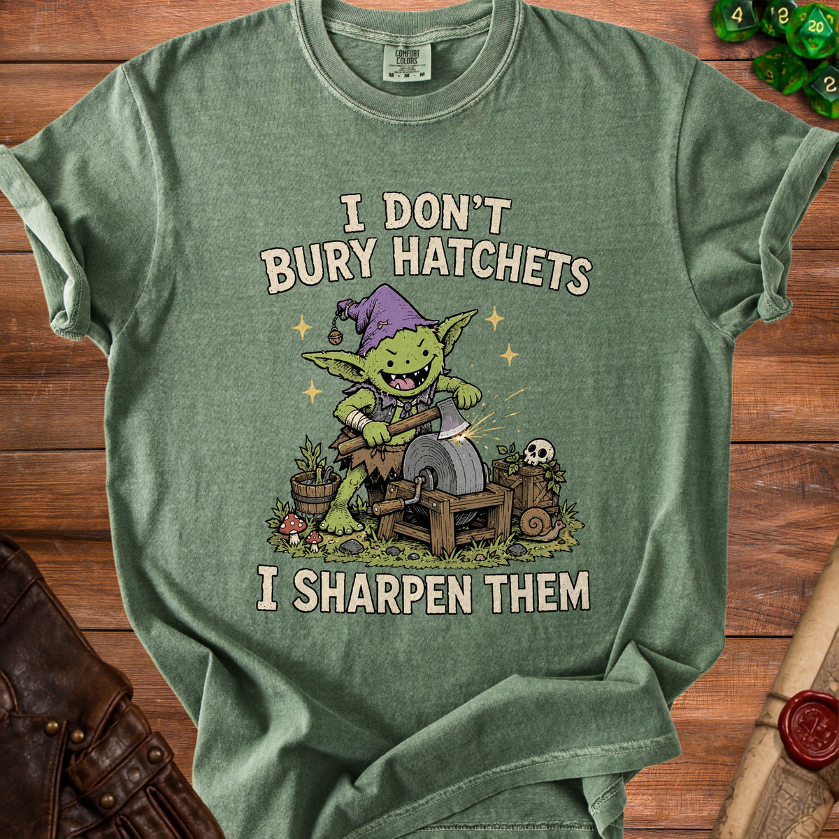 Green t-shirt with goblin sharpening an axe, text reads "I don't bury hatchets, I sharpen them."
